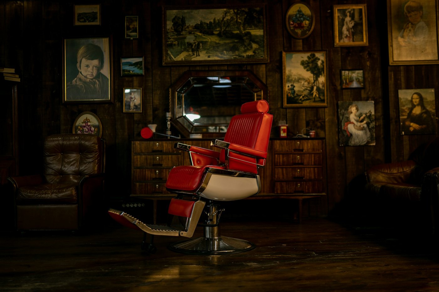 A barber finishing a fade at the first chair